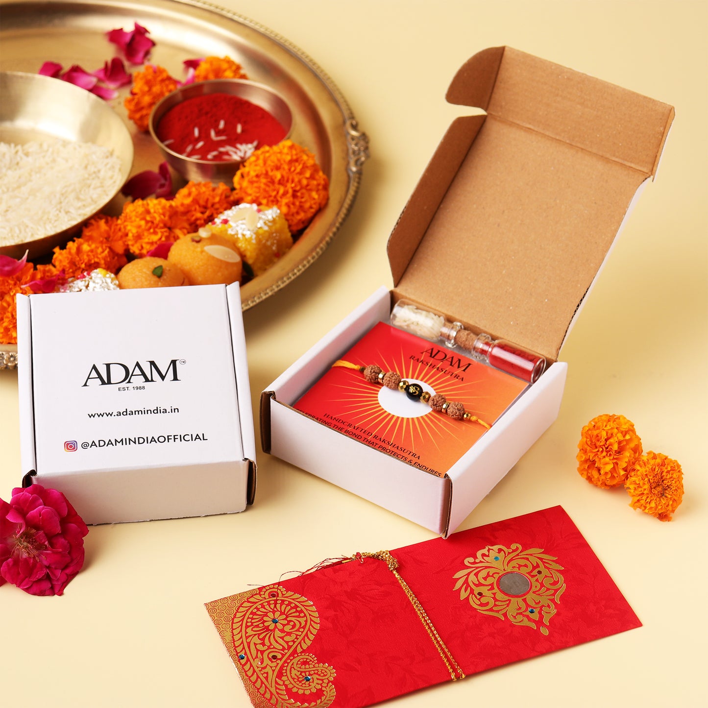 Open box with jewelry, red envelope, and floral decorations on a beige background